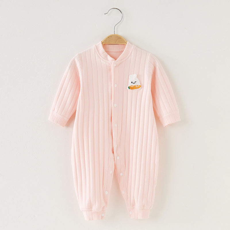 Pink ribbed baby jumpsuit with buttons, featuring a cute white bear holding a carrot embroidered on the chest. Hangs on a wooden hanger against a white background.