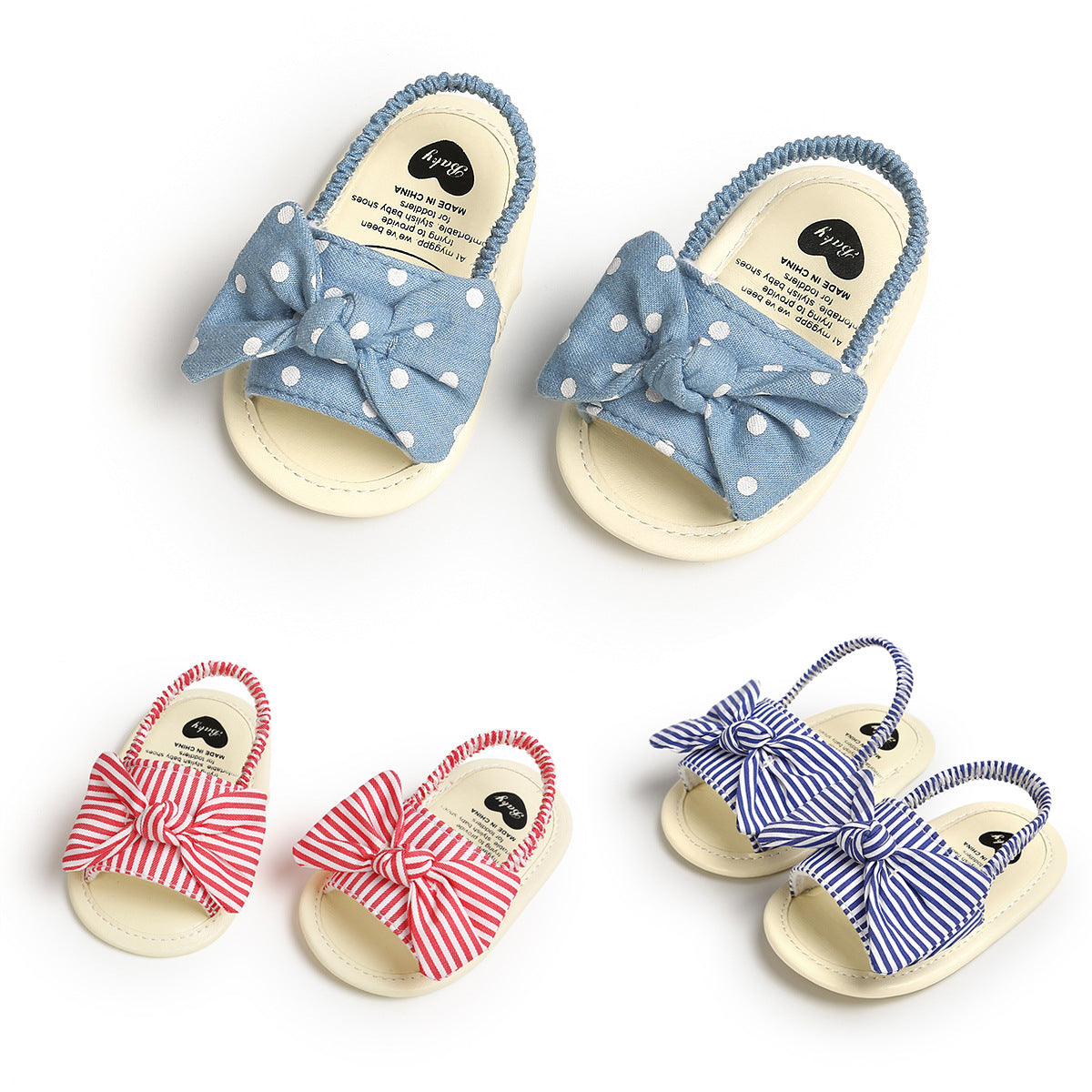 Three pairs of baby sandals with bows: blue with white polka dots, red with white stripes, and blue with white stripes. Each pair has elastic straps and soft soles.