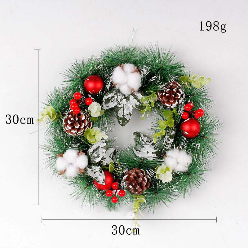A 30cm diameter festive wreath with green pine branches, red berries, cotton clusters, pinecones, and red baubles, weighing 198g.