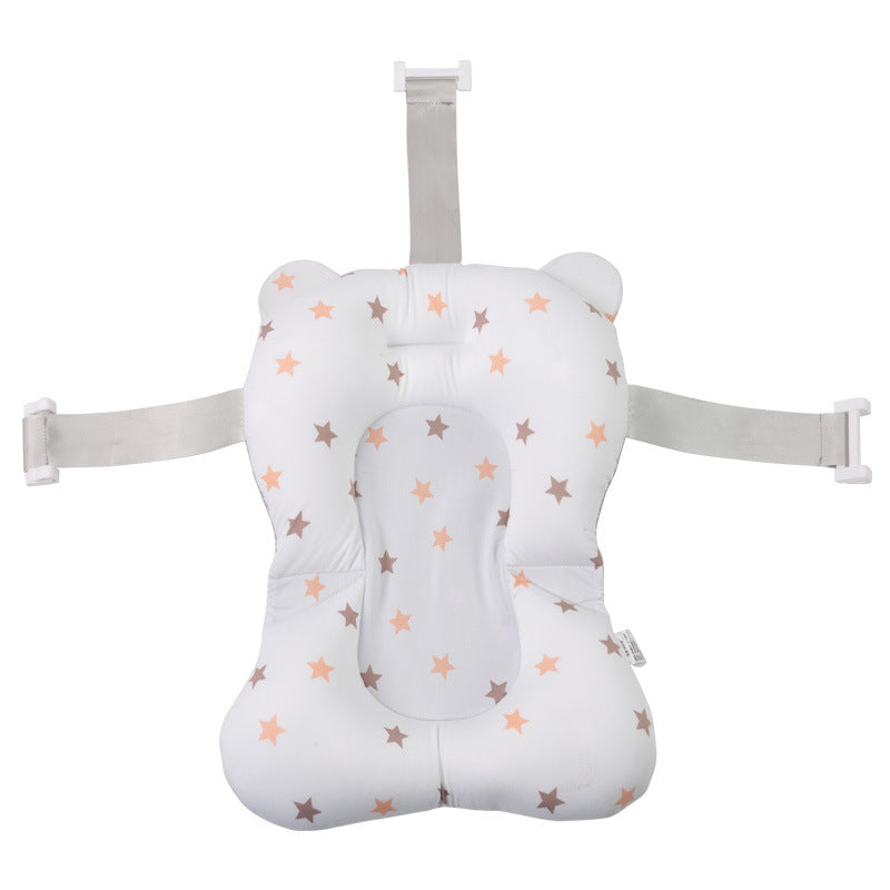 A cushioned baby bath support with star patterns in orange and gray on a white background. It features adjustable gray straps with buckles for secure attachment.