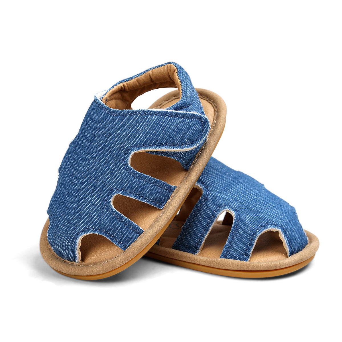 Blue denim sandals with open-toe design and tan soles. The shoes are styled with cutouts for ventilation, offering a casual and comfortable look.