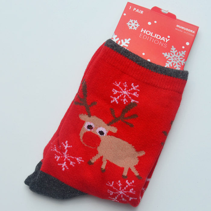 Red holiday socks featuring a cute reindeer and white snowflakes. The label reads "Holiday Editions" and displays snowflakes with festive design elements.