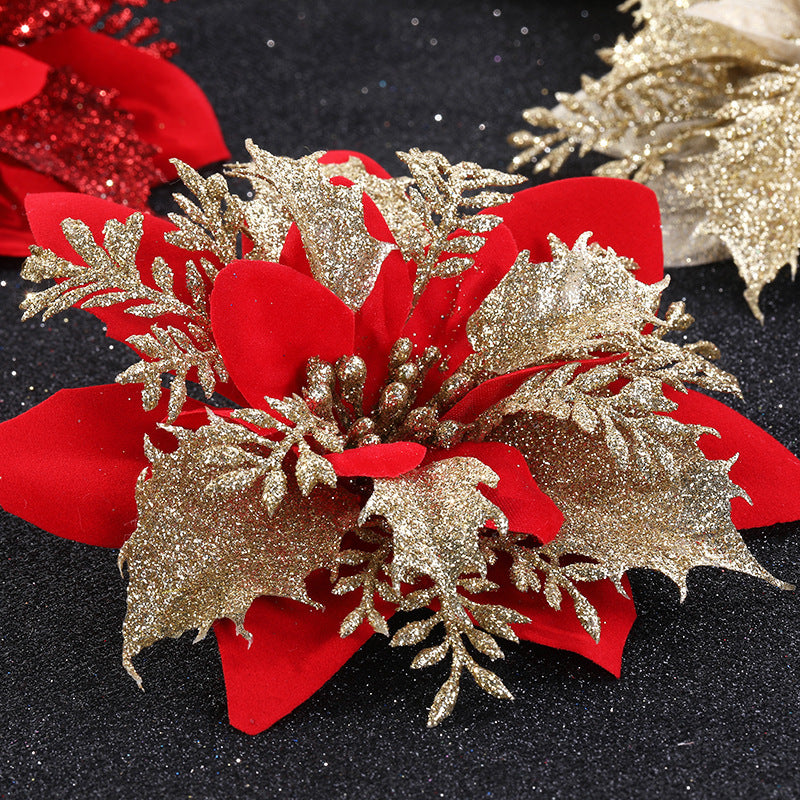 Festive decoration features red petals and shimmering gold glitter leaves, arranged on a dark background, creating a vibrant, holiday-themed contrast.