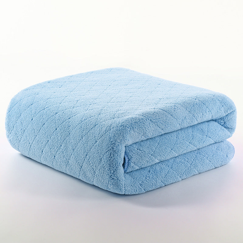 A neatly folded, soft blue blanket with a subtle diamond pattern, placed on a white background.