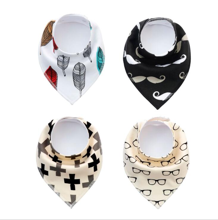 Four baby bandana bibs with different patterns: feathers on white, mustaches on black, crosses on beige, and glasses on ivory.