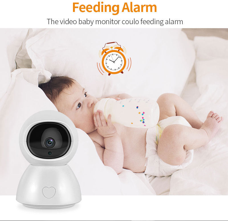 A baby in a diaper lies on a bed drinking from a bottle. A video baby monitor with a heart symbol is in the foreground. Text reads "Feeding Alarm" with an illustration of an alarm clock.