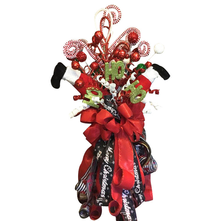Festive Christmas bouquet with red ribbons, candy canes, glittery "Ho Ho Ho" accents, Santa legs, and decorative swirls. Black and red elements add contrast.