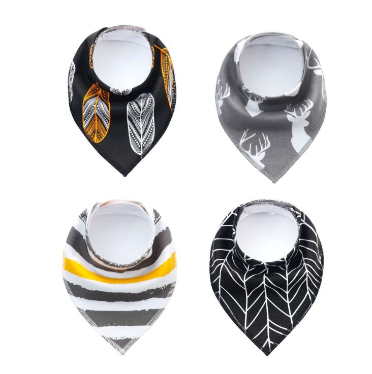 Four baby bandana bibs with different patterns: black with feathers, gray with deer, striped with yellow accent, and black with white leaves. Each has adjustable snaps.