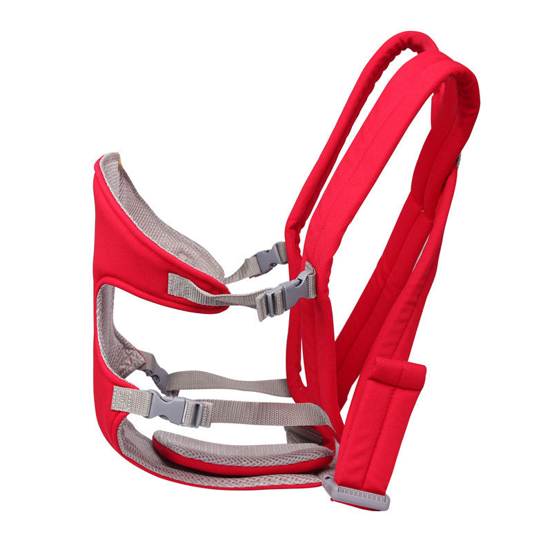 Red ergonomic baby carrier with adjustable grey straps, designed for comfortable carrying and support. The carrier features padded shoulder straps and a soft, breathable interior.