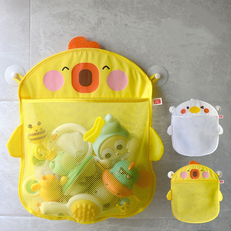 Yellow, chick-shaped mesh bath toy organizer with suction cups on a tiled wall, filled with colorful toys. Next to it are smaller, empty organizers in white and yellow.