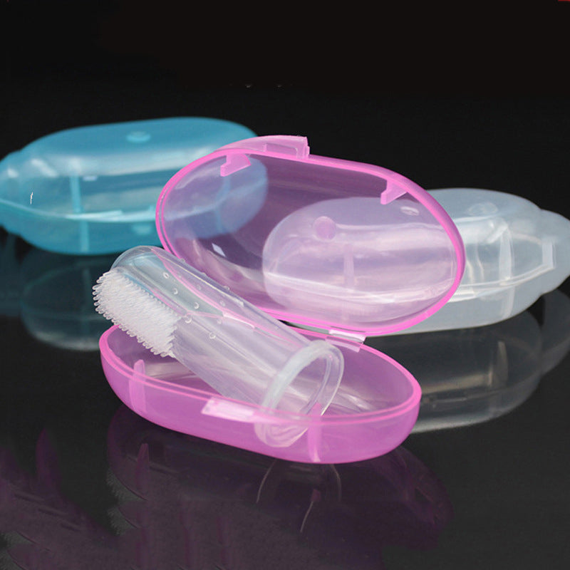 A pink, translucent plastic case containing a clear finger brush, with blue and white cases in the background, displayed on a reflective black surface.