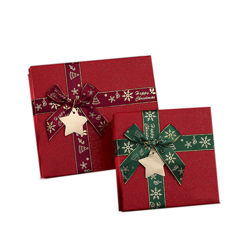 Two festive red gift boxes, one larger with a burgundy ribbon and a smaller one with a green ribbon, both adorned with snowflakes and stars, labeled "Happy Christmas."