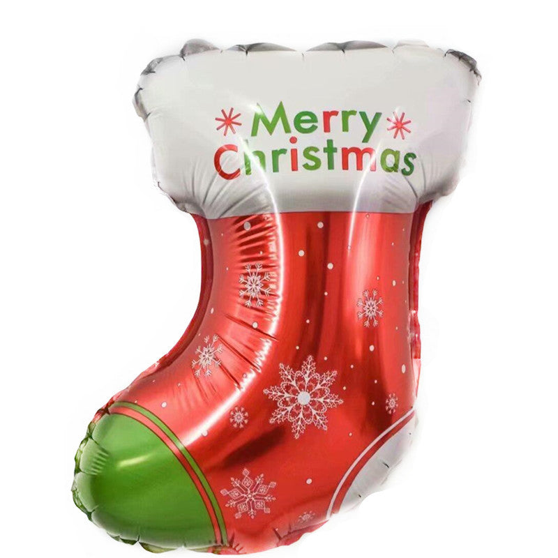 A colorful Christmas stocking-shaped balloon with "Merry Christmas" text on the white top, red body adorned with snowflakes and dots, and a green section at the heel.