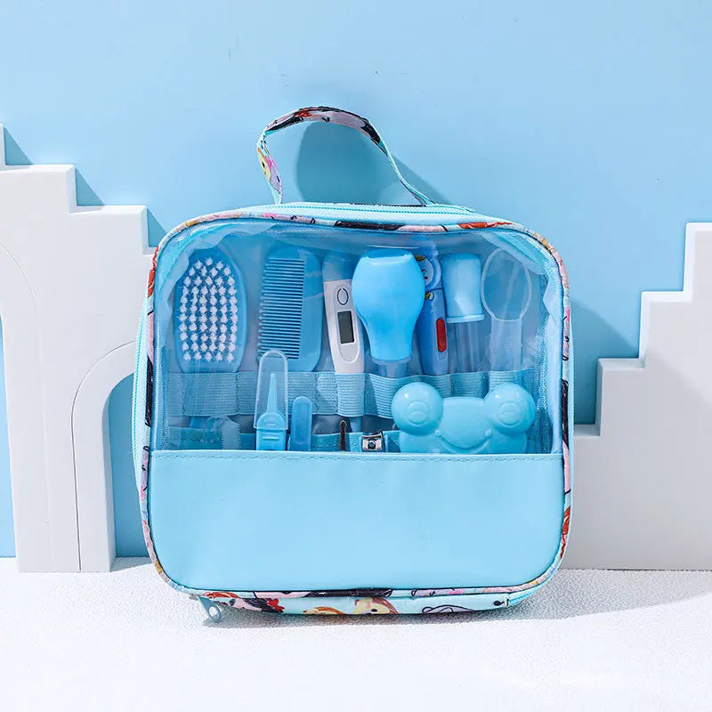 A baby grooming kit in a transparent blue case with a handle, containing a brush, comb, thermometer, and other care items, set against a light blue background with white decor.