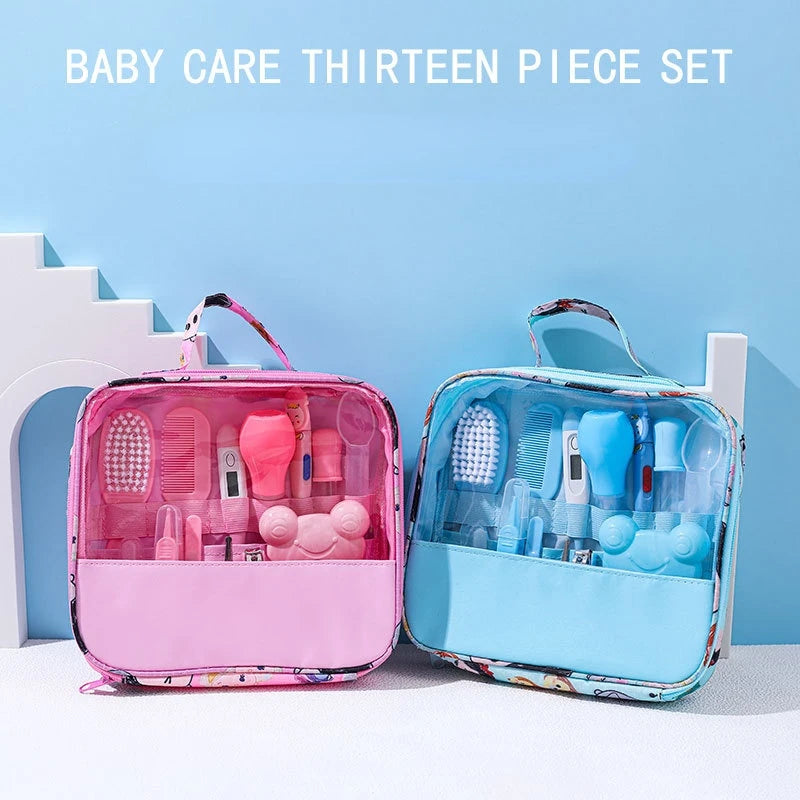 Two baby care kits with 13 items each, one pink and one blue, are displayed. Each kit includes essential grooming tools like brushes and thermometers in transparent cases.