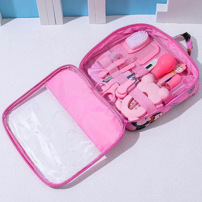 Pink children's doctor playset in an open soft case with tools including a brush, comb, scissors, and thermometer, arranged neatly in elastic straps on a white surface.