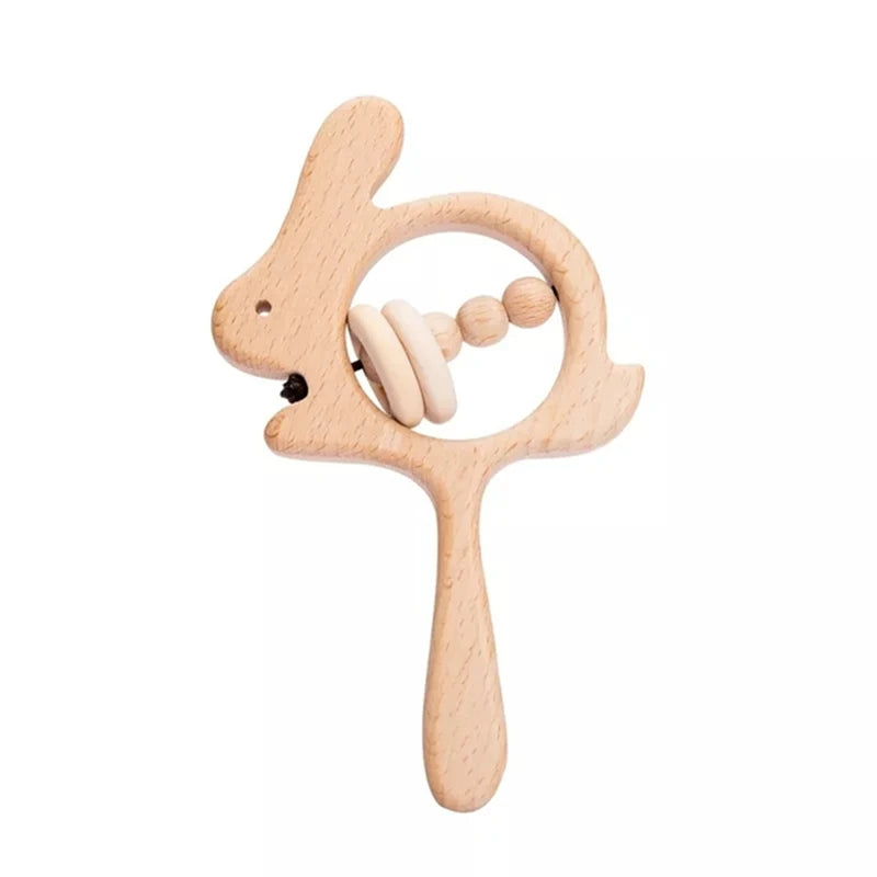 Wooden rabbit-shaped baby rattle with a handle, featuring circular beads inside. Made from natural wood, designed for sensory play and teething.