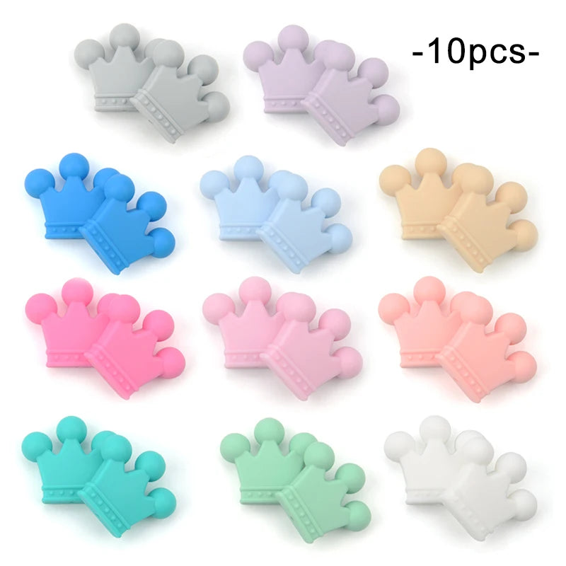Twelve pairs of silicone crown-shaped teething toys in various pastel colors, including pink, blue, green, beige, and white, arranged neatly on a white background. Text reads “-10pcs-”.