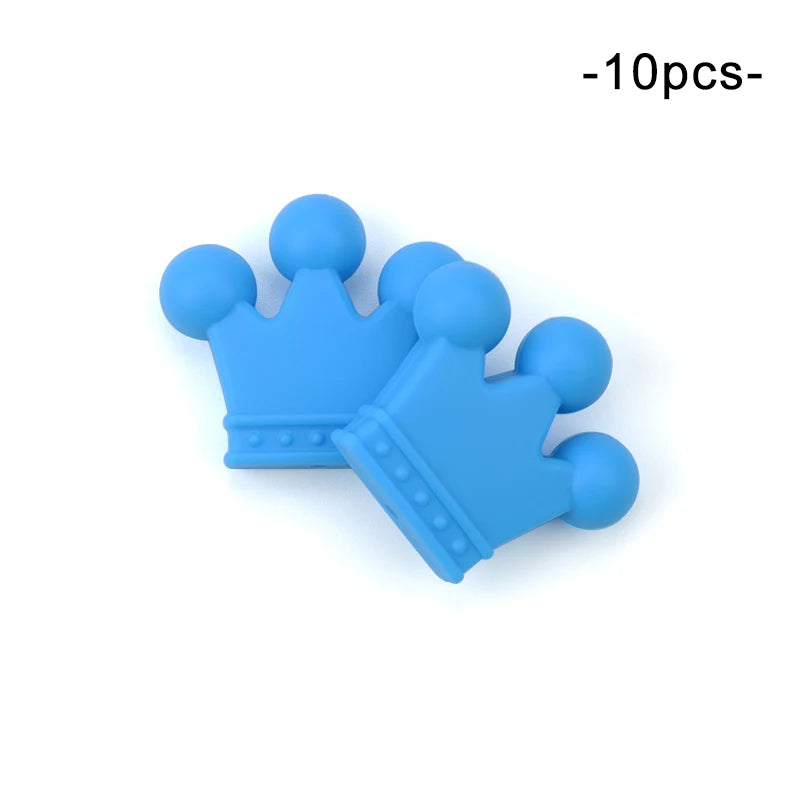 Two blue silicone crown-shaped teethers with rounded tips, designed for babies. The image shows the text "10pcs" indicating a pack of ten pieces.