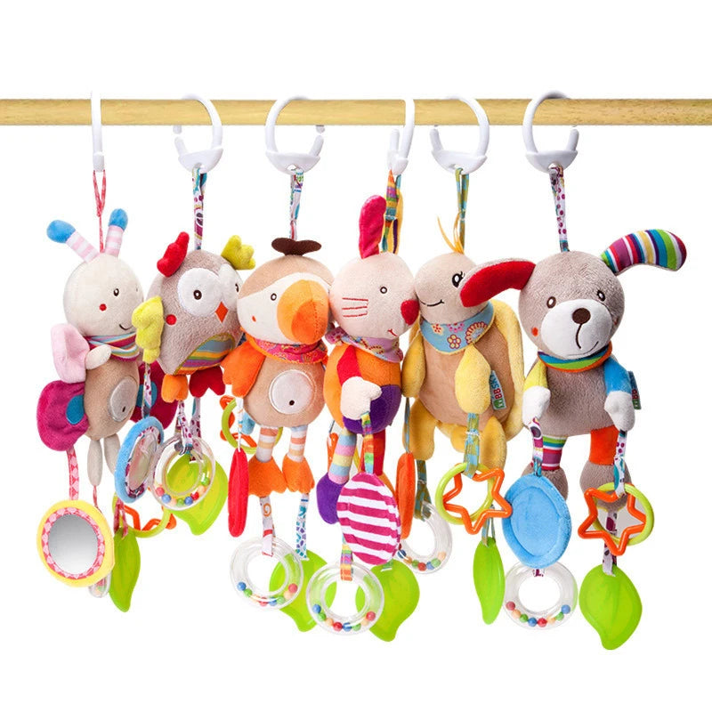 Colorful plush animal toys with rings and mirrors hang on a wooden rod. Each toy features vibrant patterns and engaging accessories, perfect for stimulating a baby's senses.