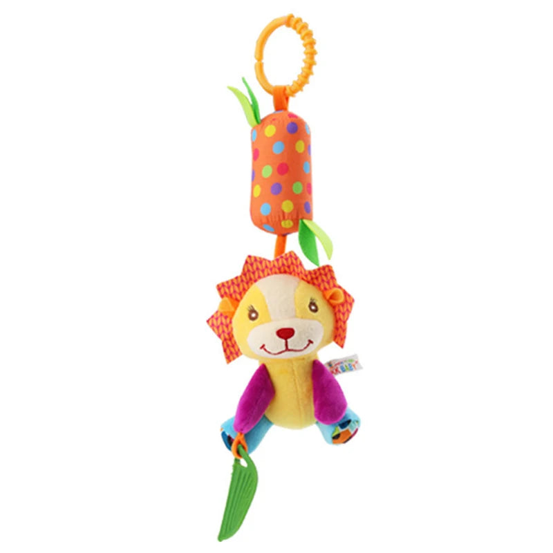 Colorful lion plush with a textured mane hangs from a ring. It features vibrant patterns, purple arms, blue legs, and a green leaf toy, attached to a polka dot cylinder.