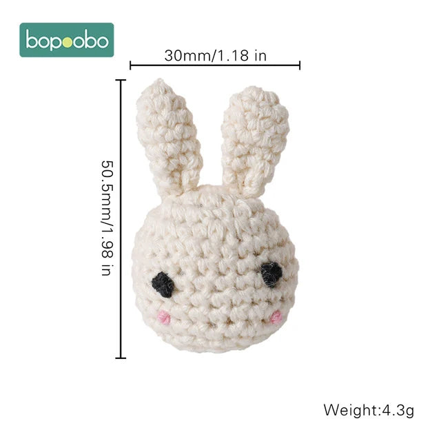 Crocheted white bunny head with long ears, black eyes, and pink cheeks. Dimensions: 50.5mm x 30mm. Weight: 4.3g. Bopoobo logo in the top left corner.