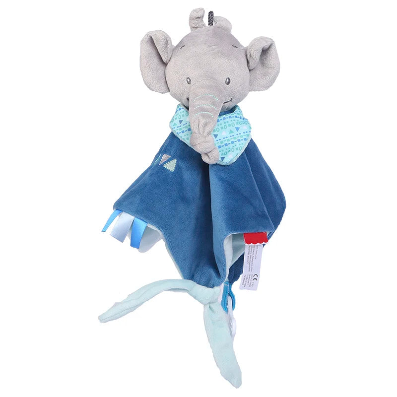 Plush elephant toy with gray head, large ears, and a trunk, wearing a blue patterned bandana. It has a soft blue blanket body with various ribbons and tags.