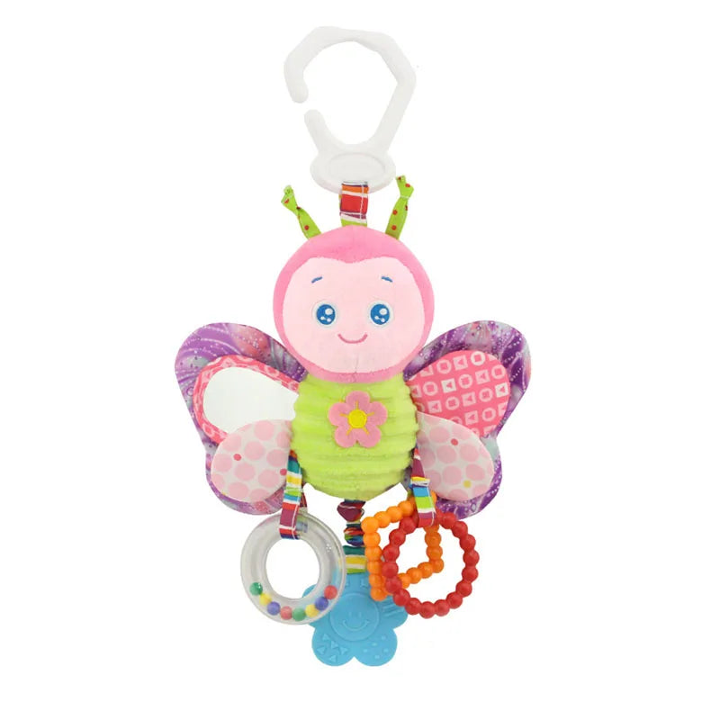Colorful plush butterfly toy with pink face, green body, and patterned wings. Includes a clip, various textured rings, and hanging accessories for infants.