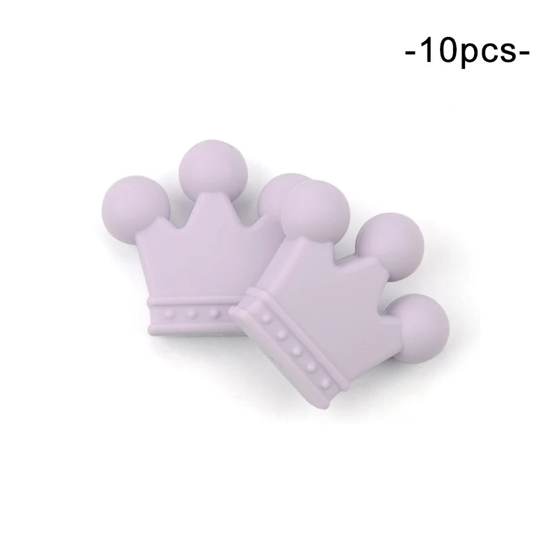 Two lavender silicone crown-shaped beads are shown. The crowns have three rounded points and decorative dots along the base. Text above reads "10pcs."