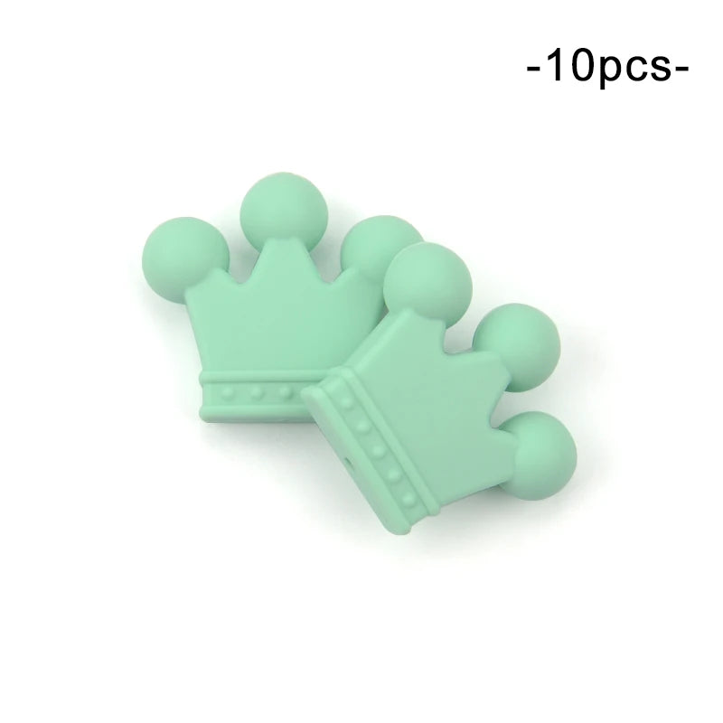 Two mint-green silicone crown-shaped beads with rounded tips, overlaid slightly. The text above reads "10pcs" indicating a set. Suitable for crafts or teething accessories.
