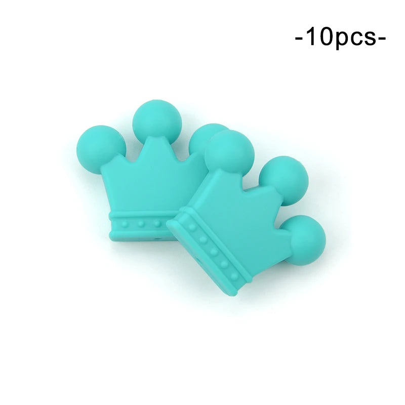 Two turquoise silicone crown-shaped beads with rounded tips and dotted base detail, positioned overlapping on a white background. Text "-10pcs-" is in the top right corner.