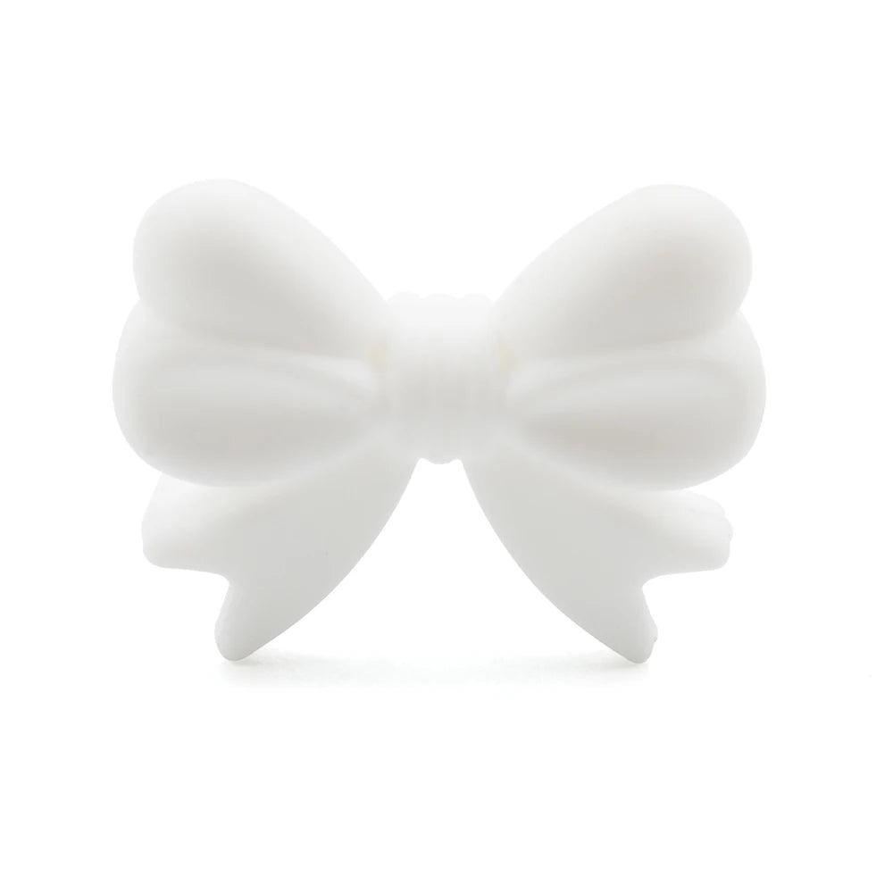 White bow-shaped object with smooth, rounded edges, featuring evenly looped sections and a central knot. The background is plain white, highlighting the bow's design.