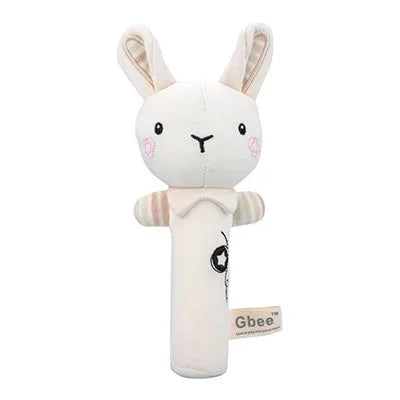 Soft plush bunny rattle toy with embroidered eyes and pink cheeks, long ears, and a cylindrical handle. The brand label "Gbee" is attached to the side.