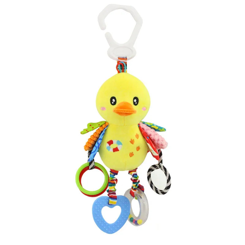 Yellow plush duck toy with colorful wings and patterns. It has a white hanging clip and features various textured rings and teething shapes dangling from its legs.