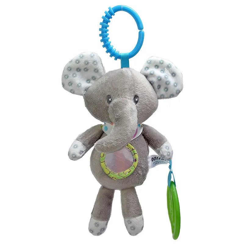 Gray plush elephant toy with patterned ears and feet, hanging from a blue ring. It features a circular window on its belly and holds a green teething ring.