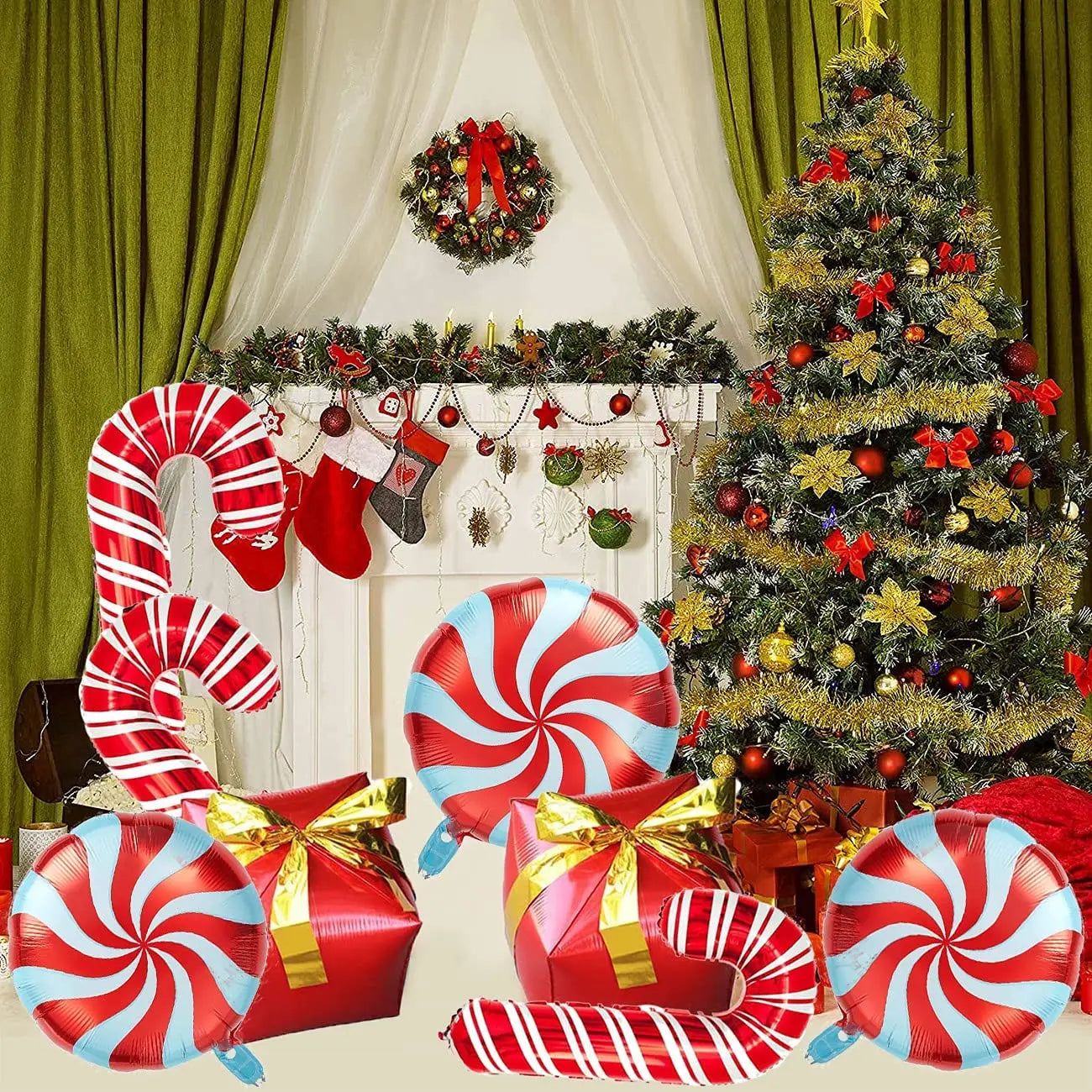 Festive room with a decorated Christmas tree, stockings on a mantel, and green curtains. Giant candy cane and peppermint balloons with gift boxes in front.