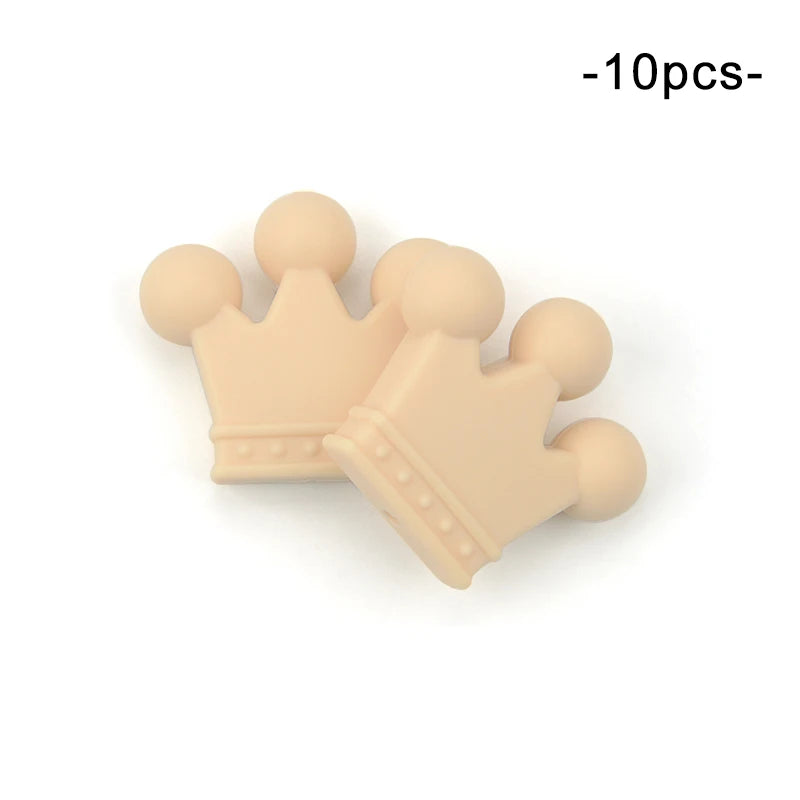 Two beige, silicone teething toys shaped like crowns with smooth, rounded points, shown on a white background. Text in the corner reads "10pcs."