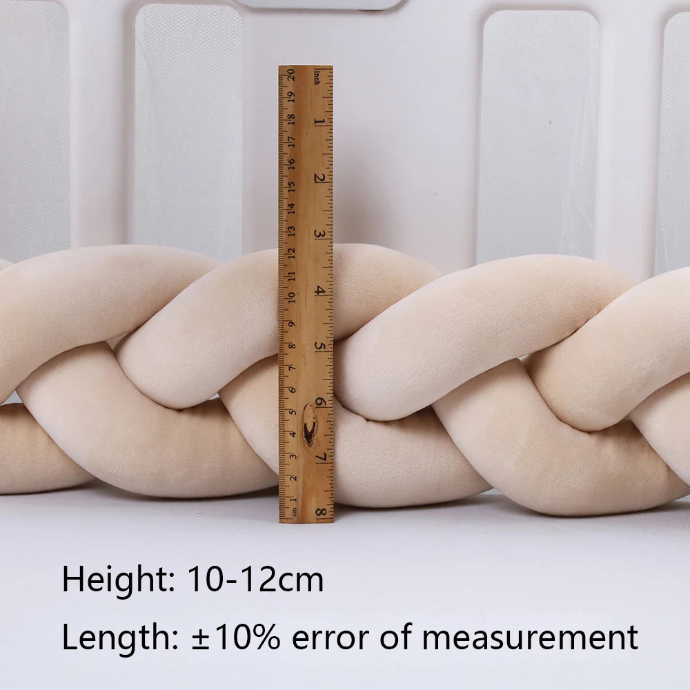 Wooden ruler measuring a soft, beige, braided cushion against a white background. Text on the image notes height as 10-12cm with a length measurement error of ±10%.