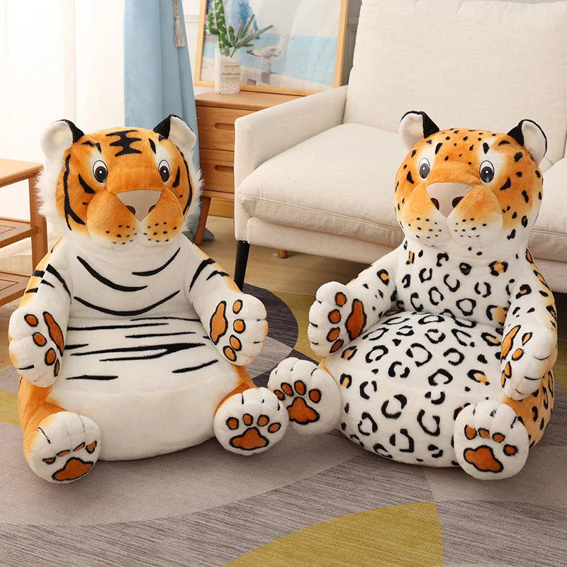 Two large plush animal chairs, one tiger and one leopard, are placed on a patterned rug near a sofa. The room is cozy with soft, natural lighting.