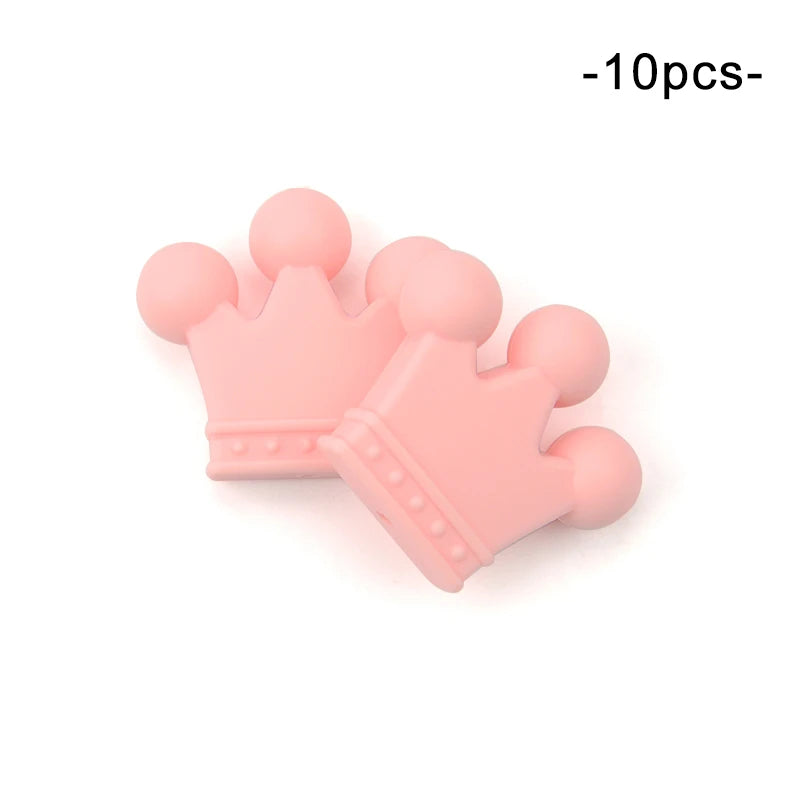 Two pink silicone crown-shaped teething toys with rounded edges and small dot details, shown on a white background. Text reads "10pcs" in the top right corner.