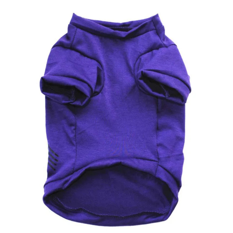 Purple dog shirt with short sleeves and a high collar, designed for pet comfort. Features minimalistic stitching with a simple cut for easy wear.