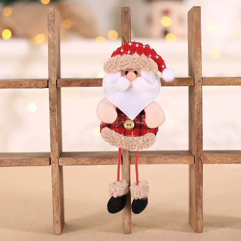 Cute Santa ornament with a red hat and plaid outfit sitting on a wooden shelf. The background is softly blurred with warm, glowing lights.