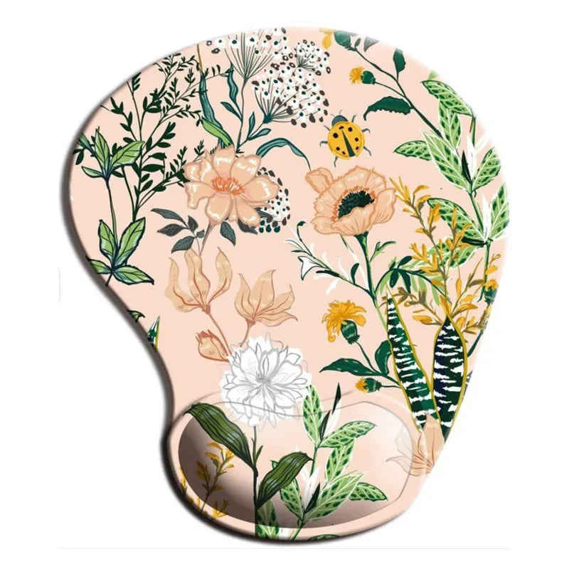 Floral-patterned ergonomic mouse pad with wrist support, featuring various flowers and leaves on a pale pink background, accented by a small yellow ladybug.
