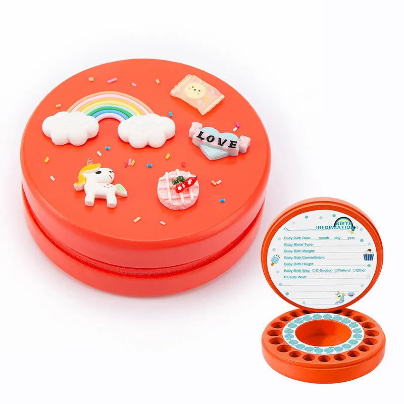 Red circular tooth storage box with unicorn, rainbow, and love decorations on the lid. The open lid reveals baby information fields and 28 compartments for baby teeth.