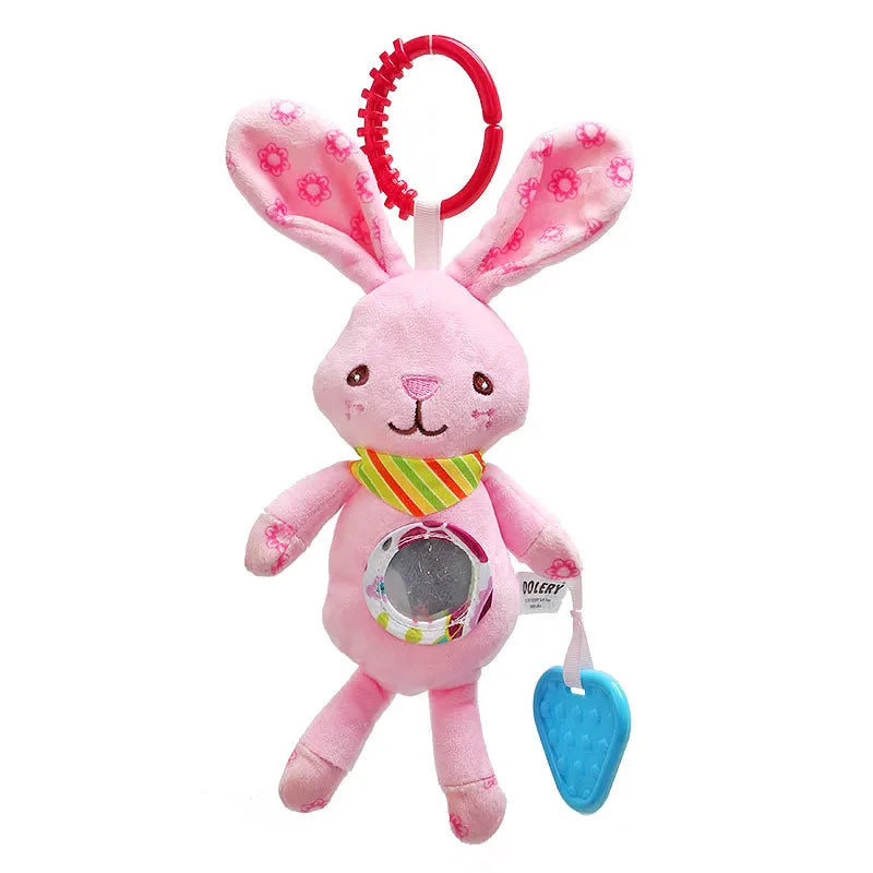 Pink stuffed bunny toy with long ears, floral patterns, and a striped scarf. It has a red ring on top, a reflective belly, and a blue teething heart hanging from one paw.