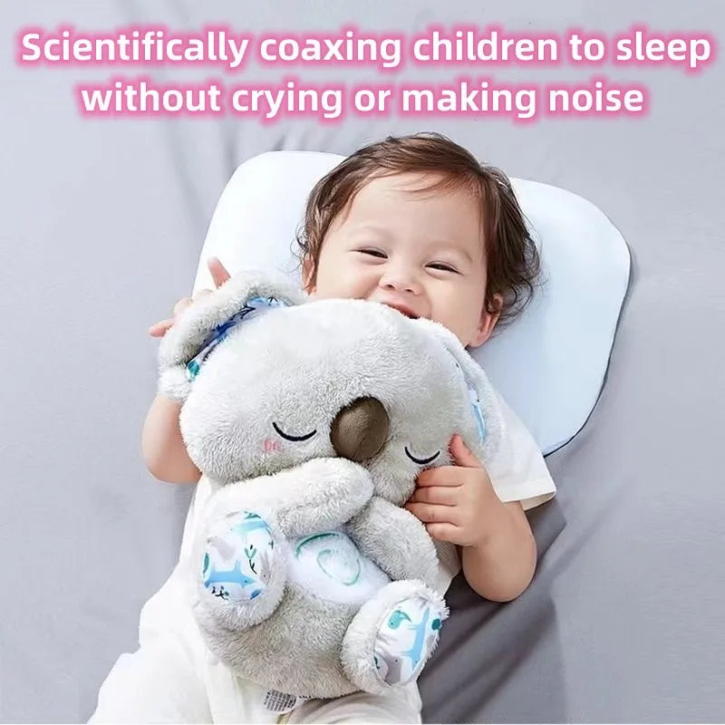 Smiling baby holds a plush koala toy while lying on a pillow. Text above reads, "Scientifically coaxing children to sleep without crying or making noise."