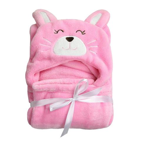 A fluffy pink baby blanket folded into a bunny shape, with embroidered facial features and ears. Tied with a satin ribbon bow, it looks soft and cozy.