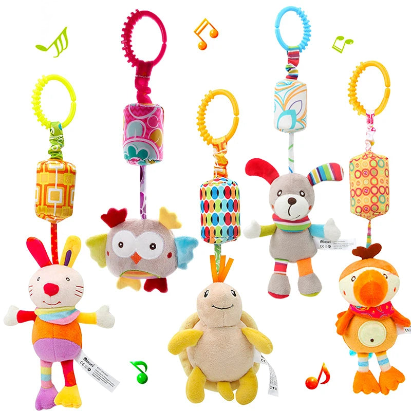 Five colorful hanging plush toys with musical notes, featuring a rabbit, owl, dog, turtle, and bird. Each toy has a vibrant design and a ring for attachment.