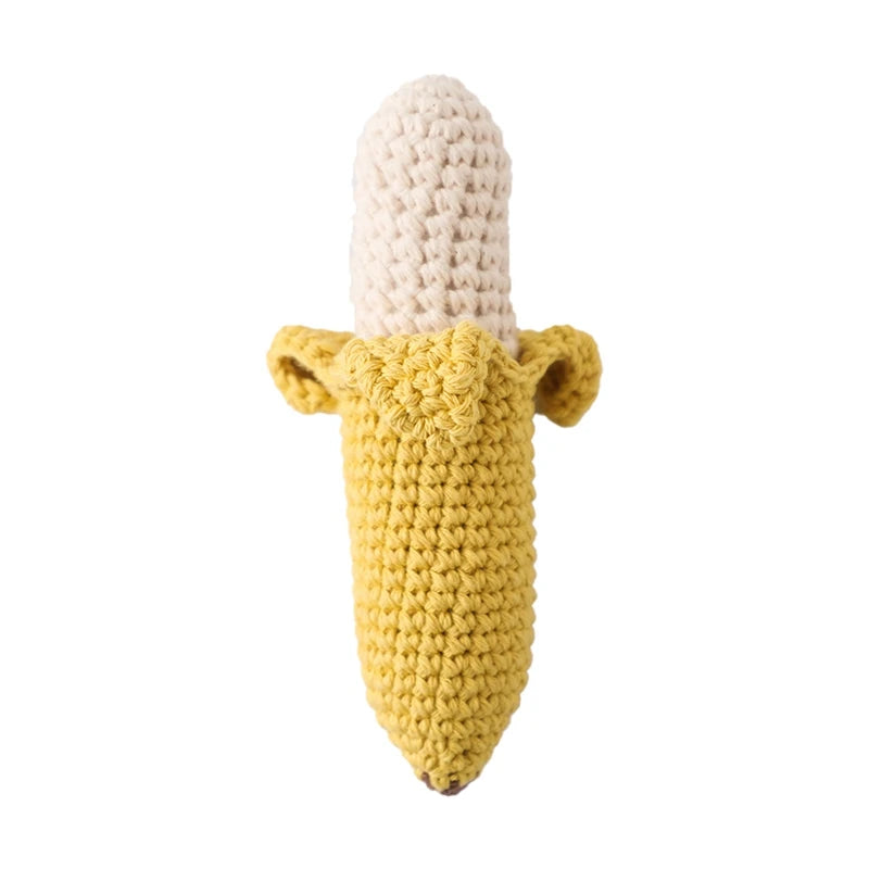 Crocheted banana toy with a yellow peel partially open, revealing the cream-colored fruit inside. The handmade design emphasizes texture and resembles a peeled banana.