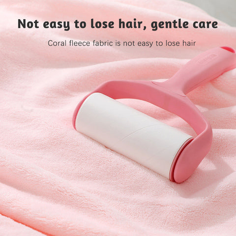 A pink lint roller on a soft coral fleece fabric, emphasizing gentle care and minimal fuzz shedding. Text above states, "Not easy to lose hair, gentle care."